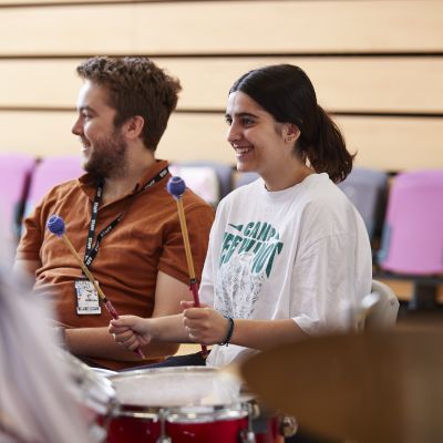Student plays the drums